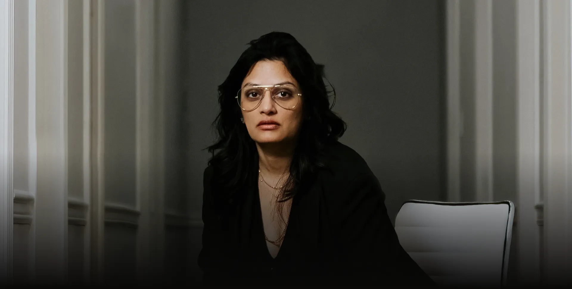 Dr. V at her desk — physician-led precision wellness